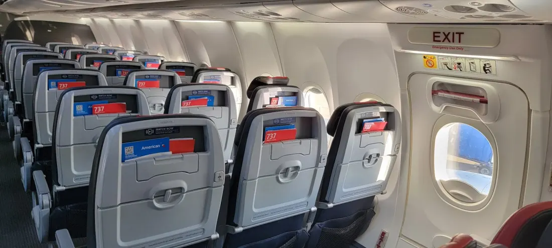 Passenger Reads Her Seatmate's Cruel Texts Mid-Flight — The Fallout Included Free Baileys and a Crushed Bag of Chex Mix